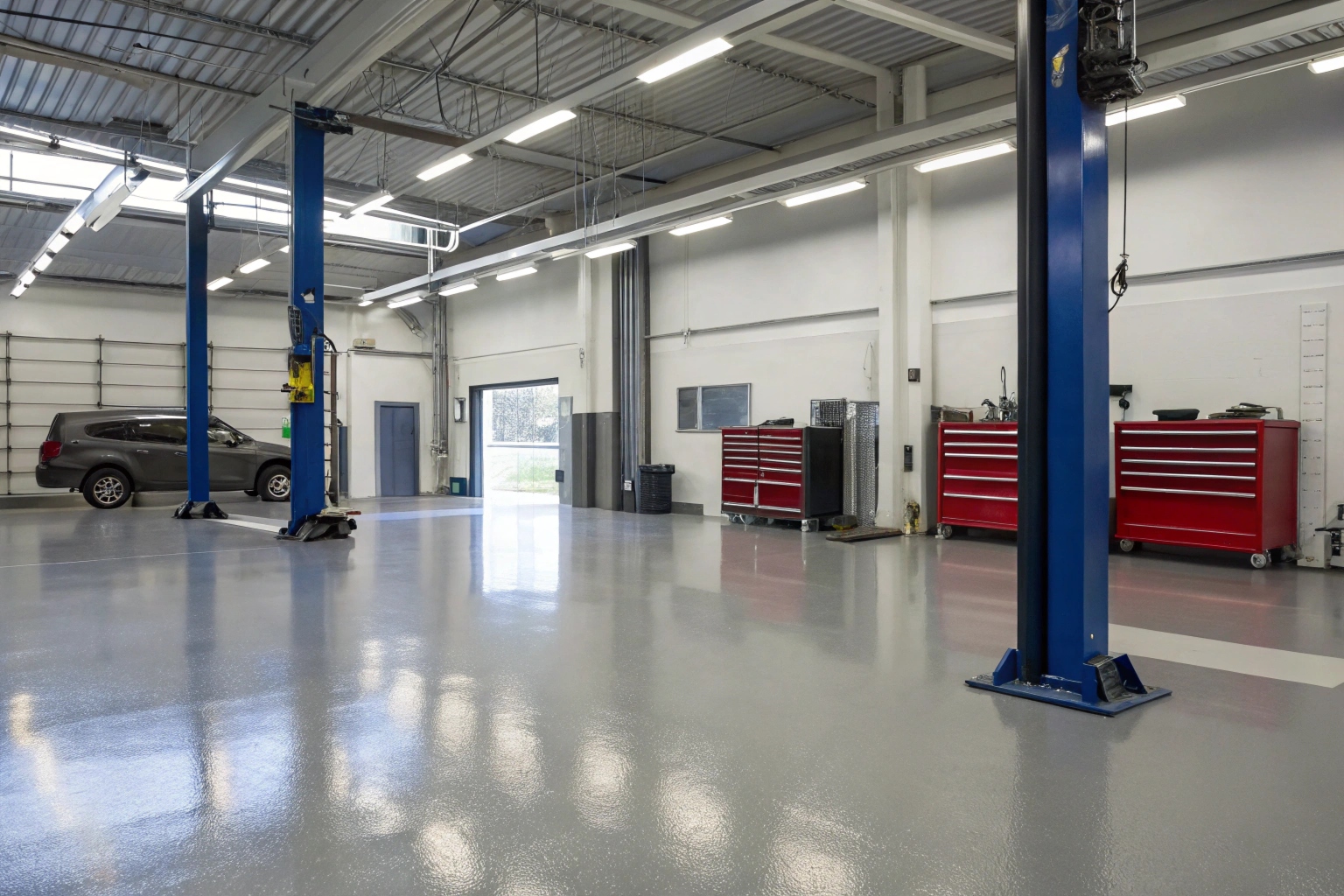 Chemical-resistant epoxy flooring installed in a Taren Point Road auto workshop