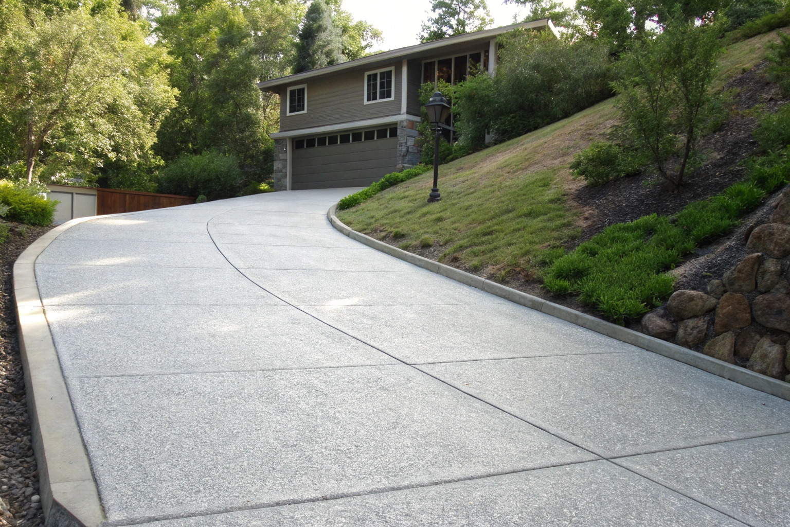 Sloped driveway with non-slip epoxy coating on a Gymea hillside block