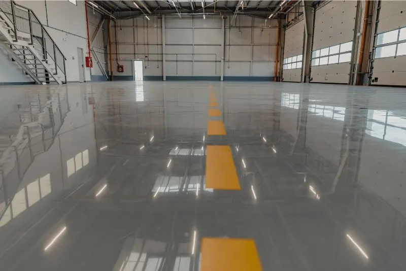 Shiny epoxy flooring installed in a commercial garage space