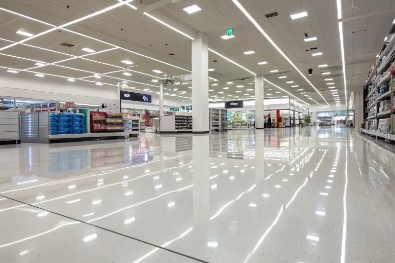 Professional epoxy retail flooring installation in Sutherland Shire store showing glossy reflective surface
