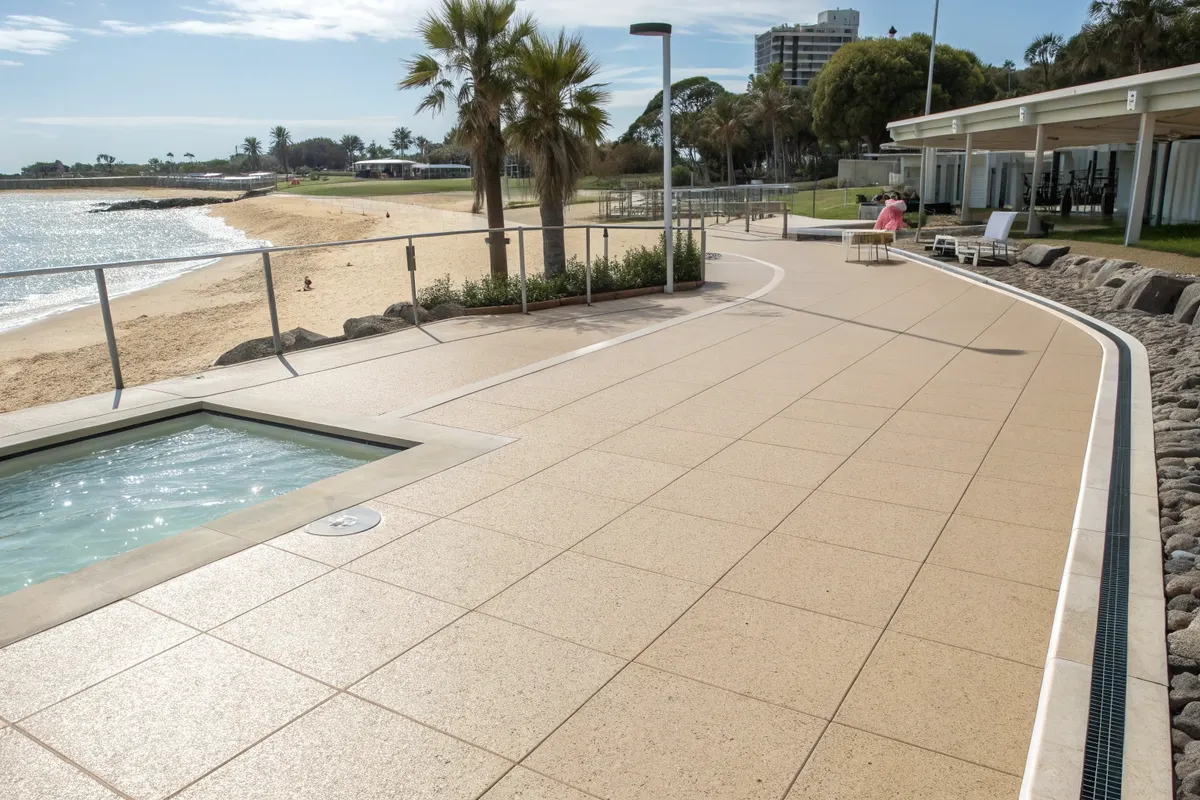 Outdoor pool deck area with light-coloured epoxy flooring